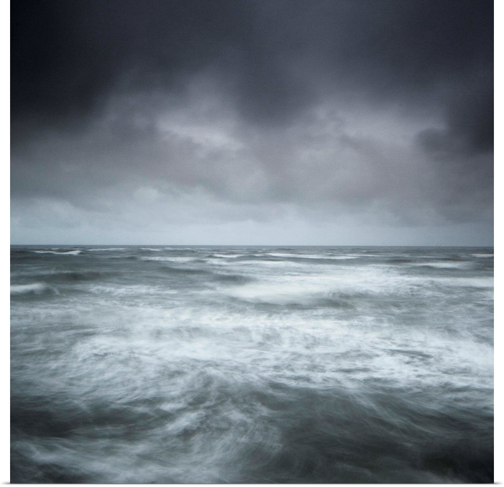 A stormy seascape, minimalist with swirling waves and a stormy sky in greys, greens, blues and silvers.