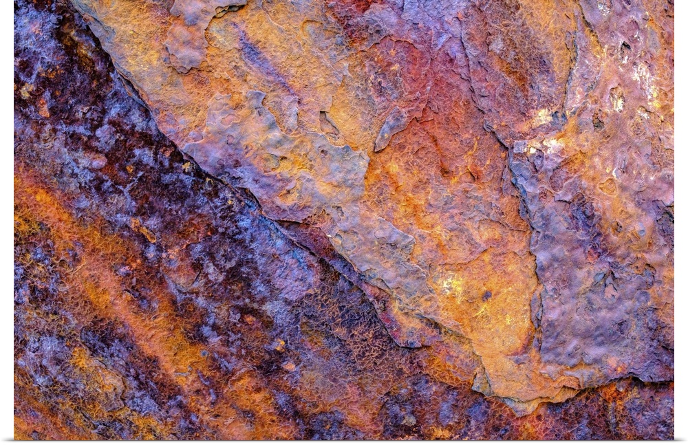 A close-up photograph of a multi-colored rock in purple and orange.
