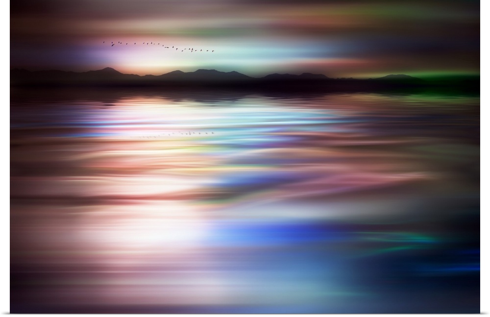 Abstract photograph of a flock of birds flying above a dreamy, wavy body of water with a mountain line silhouette in the d...