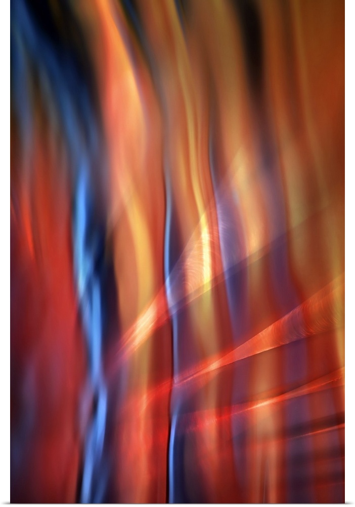 Abstract photograph of blurred and blended colors and flowing lines, with blue and orange waves.