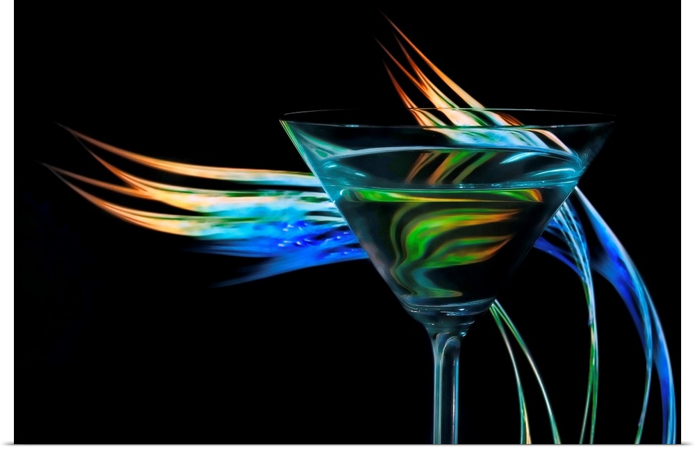 Up-close photograph of a martini glass with colorful waves of light behind it.