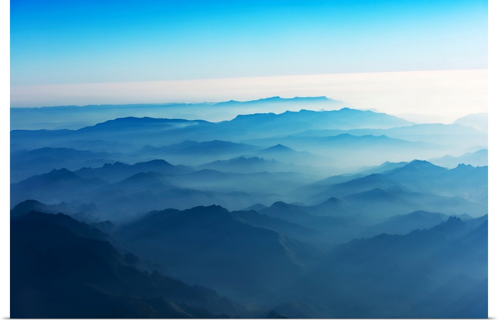 Mountains of Laos seen from the sky in a bluish atmosphere at sunrise