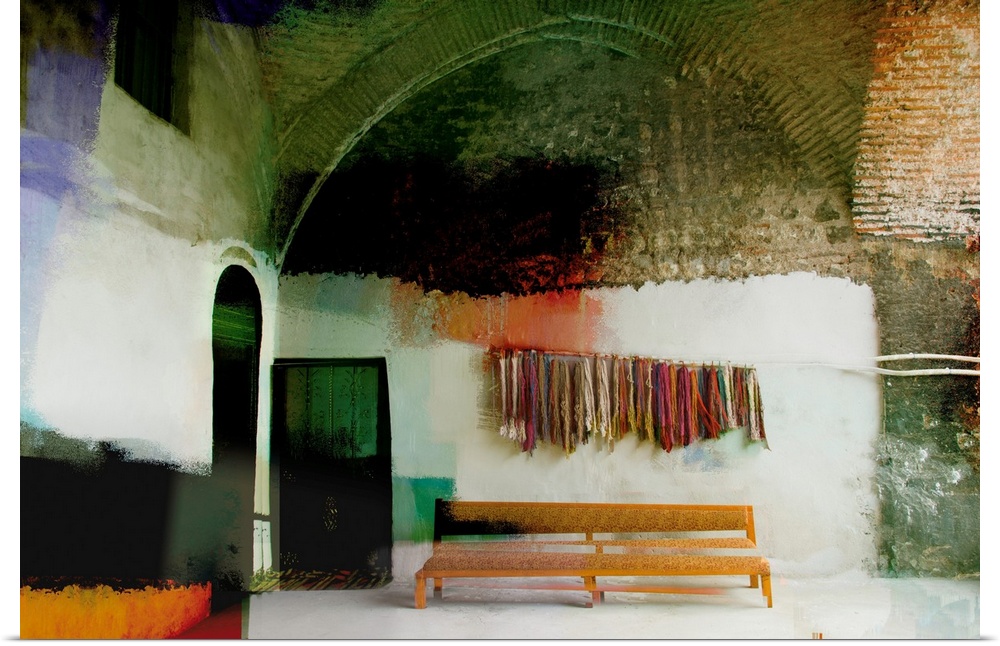 Altered photograph of building with bundles of yarn hanging on the wall over a bench.