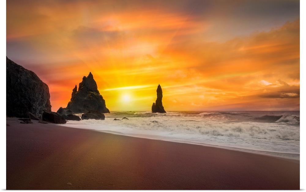 Fine art photograph of the sun shining over a sandy beach with foamy waves.