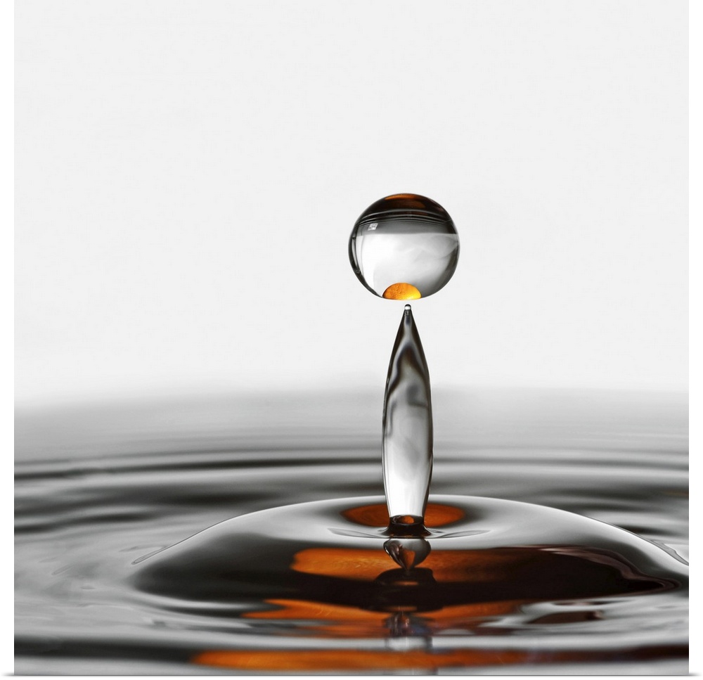 A photograph of a water droplet rising up from a splash.