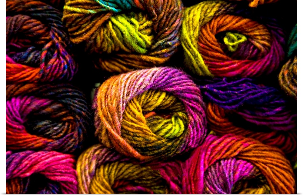 A close up of richly coloured knitting yarns in a kaleidescope of colours.