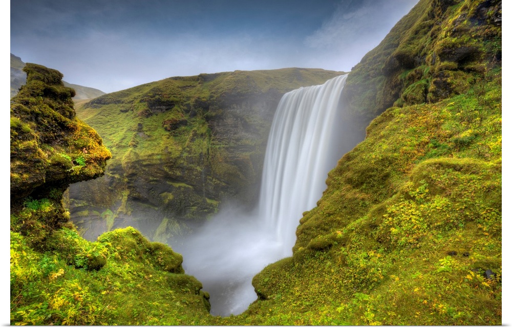 Fine art photograph of a waterfall in Iceland surrounded by mossy rocks.