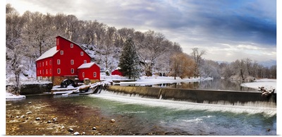 Winter Landscape Of A Red Gristmill And A Waterfall