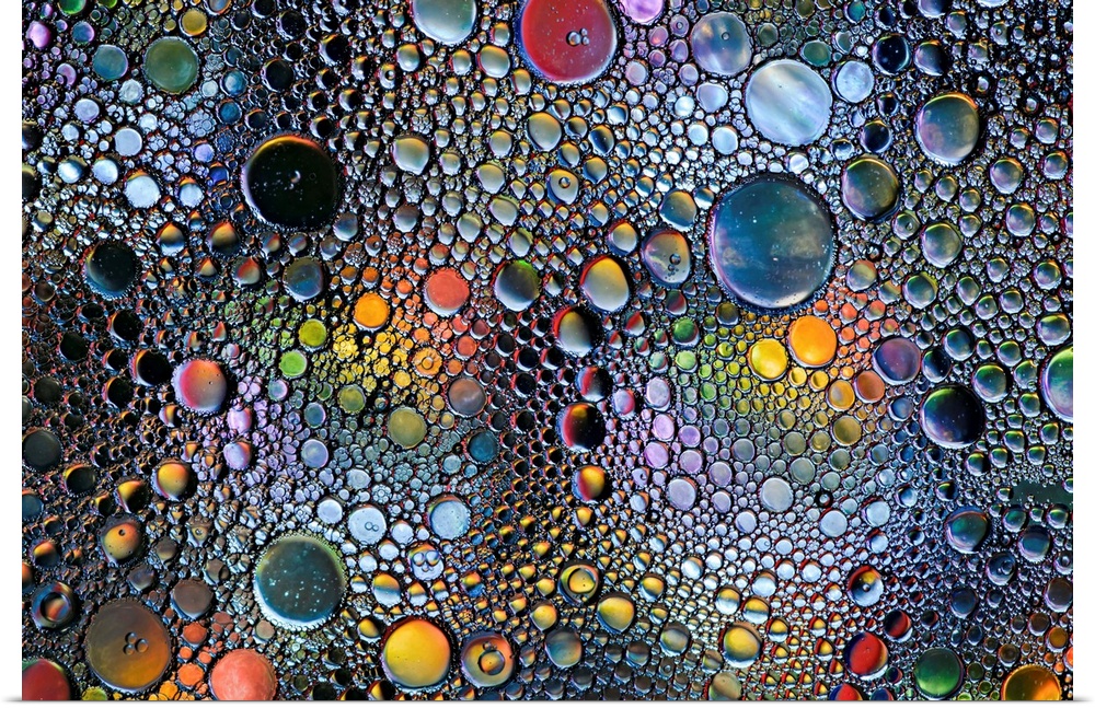 Abstract photo of a multitude of bubbles in rainbow colors of different sizes.