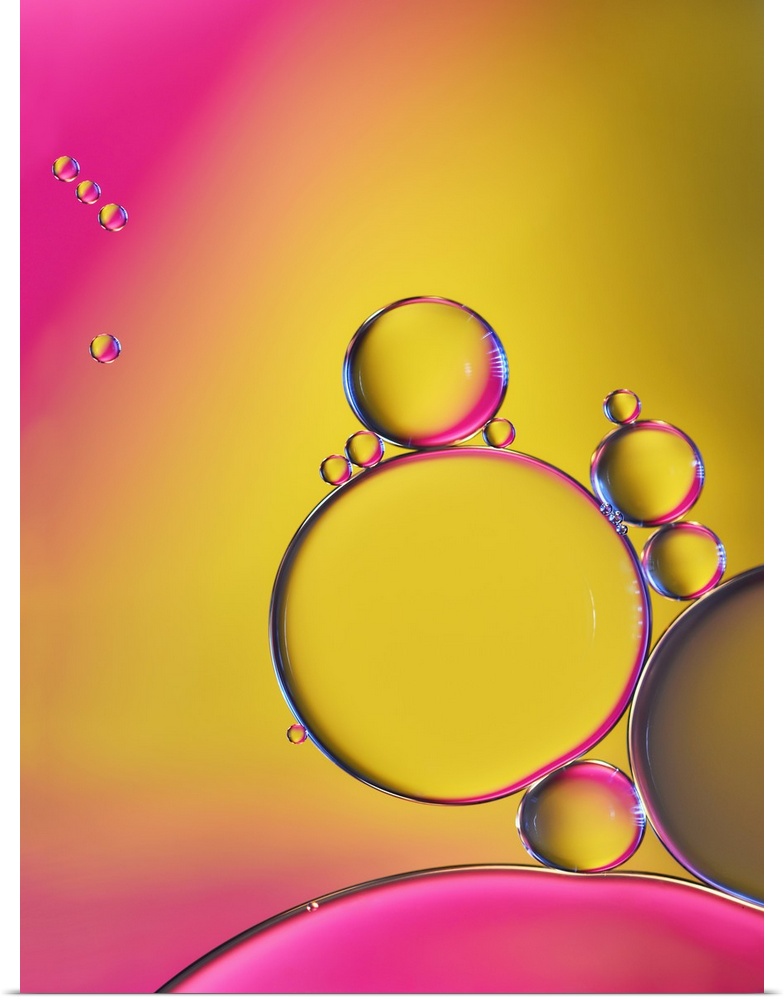A macro photograph of a cluster of bubbles against a colorful background.