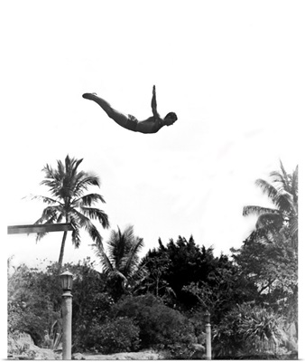 1940's Man Poised Midair Jumping From Diving Board Into Pool