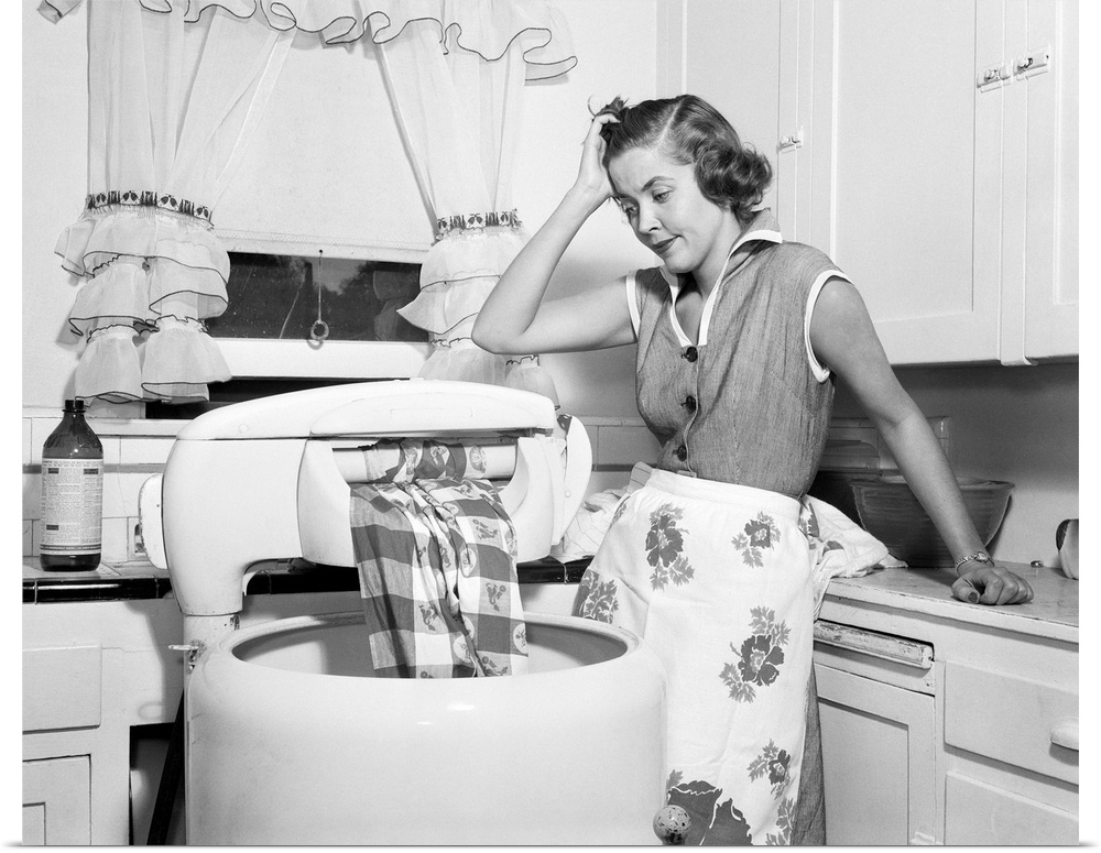 1950s Frustrated Housewife With Jammed Wringer On Clothes Washing Machine In Kitchen.