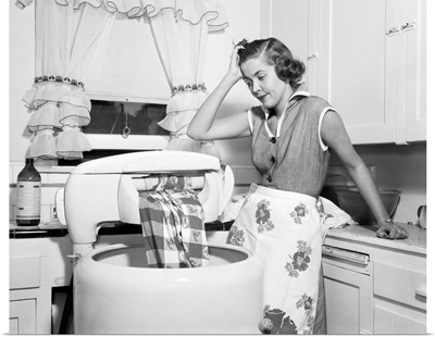 1950s Frustrated Housewife With Jammed Wringer On Clothes Washing Machine In Kitchen