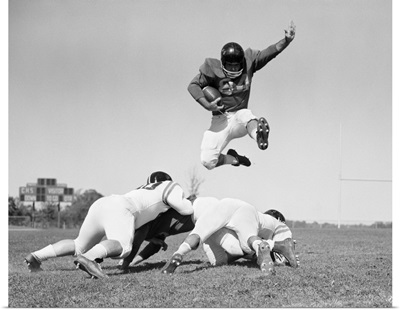 1960's Football Player Jumping Over Blocked Players