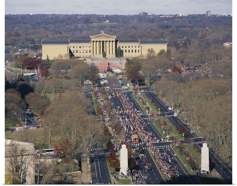 The art museum in Philadelphia is photographed from a high angle view as crowds of people walk toward the entrance.
