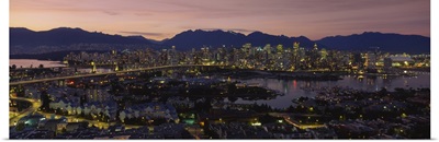 Aerial view of a city lit up at dusk, Vancouver, British Columbia, Canada