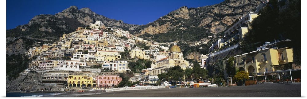 View from below of the buildings stacked upon the hill off the Amalfi Coast in Positano, Italy.