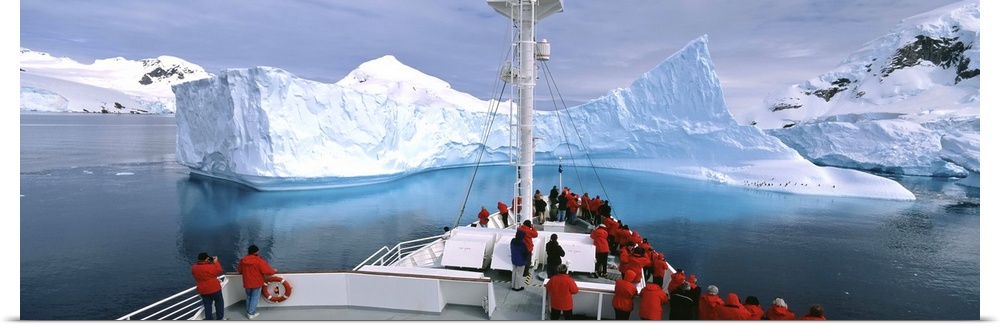 Antarctica, Antarctic Peninsula, Tourists standing on a cruise ship watching at iceberg