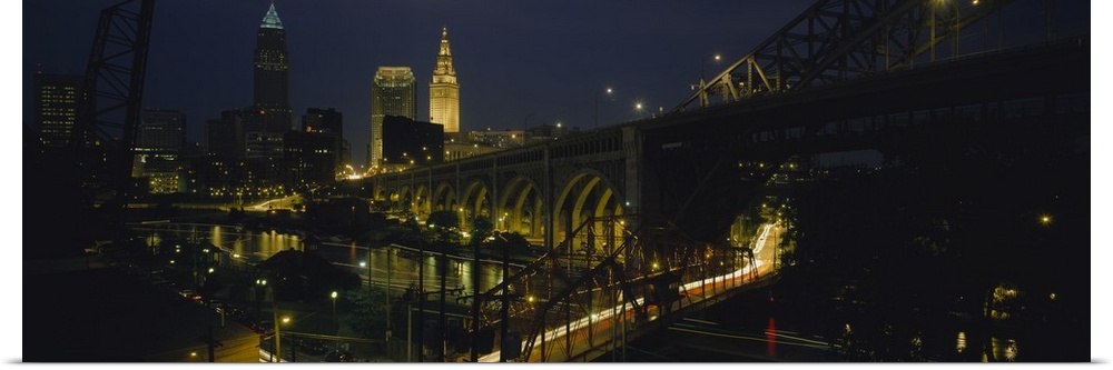 Lit up downtown buildings and bridges over the Bridge Creek at night in Cleveland, Ohio.