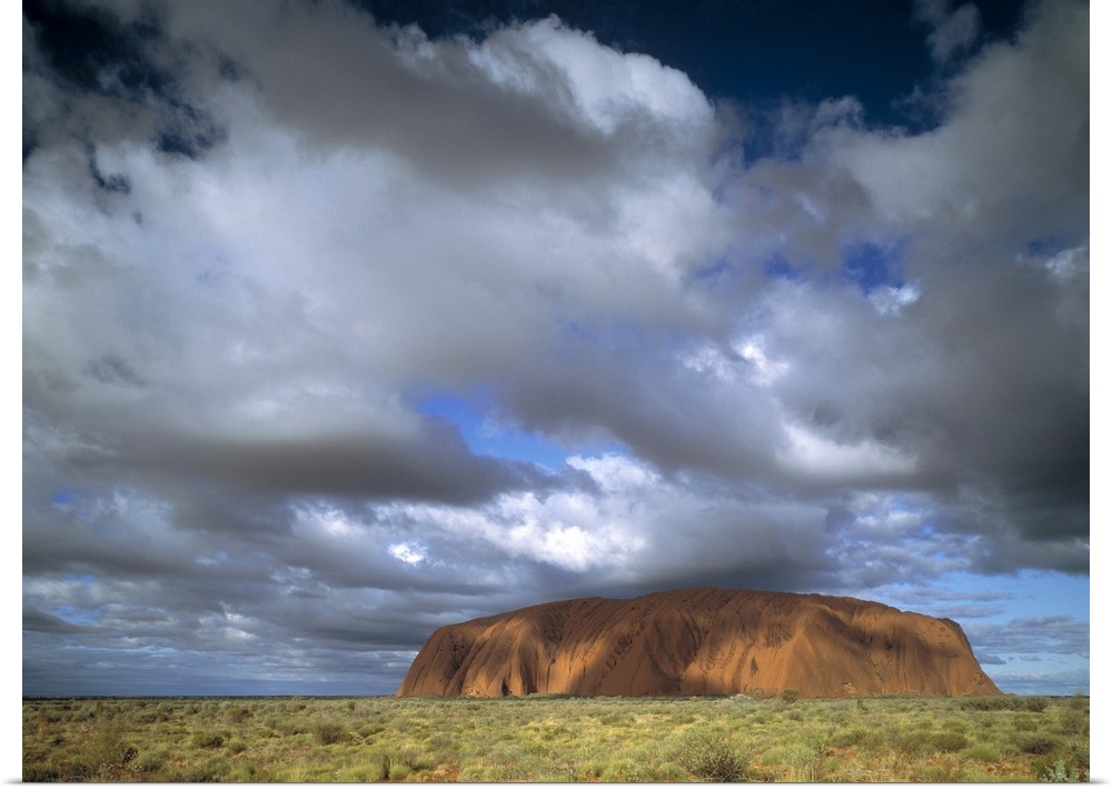 This is a landscape photograph of the mountain island landmark in the outback under growing cloud cover.