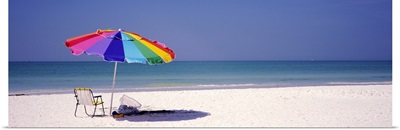 Beach umbrella and a folding chair on the beach, Fort De Soto Park, Tierra Verde, Florida