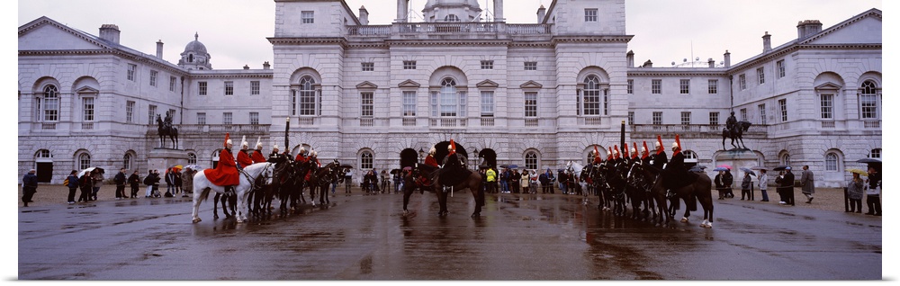 Black horse guards in front of a building, London, England