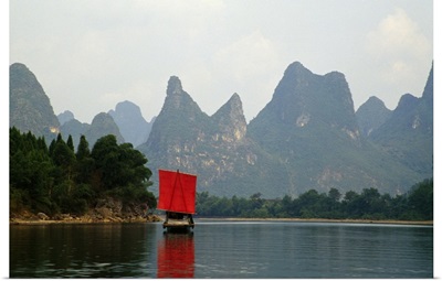 Boat on Li River, mountains in mist, Guilin, China.