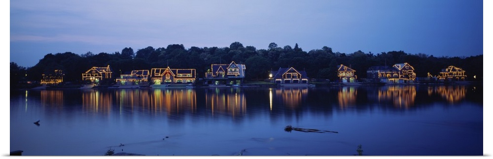 Panoramic photo of Boathouse Row in Philadelphia, Pennsylvania (PA) at sundown. Lights on the houses are reflected in the ...