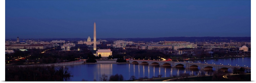 Panoramic shot taken of Washington DC with the Washington monument most noticeable and a river shown in front of it.