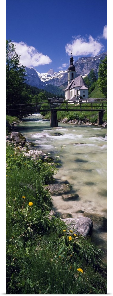 Bridge over stream below country church, Bavarian Alps, Germany