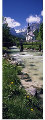 Bridge over stream below country church, Bavarian Alps, Germany