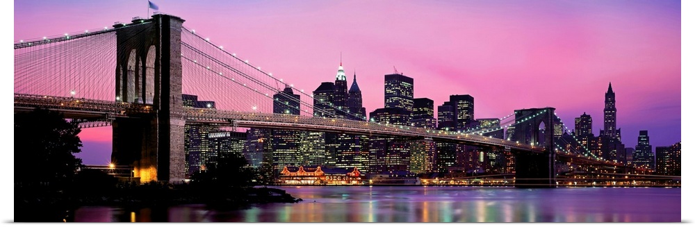 This is a panoramic photograph of the famous suspension bridge and city skyscrapers.
