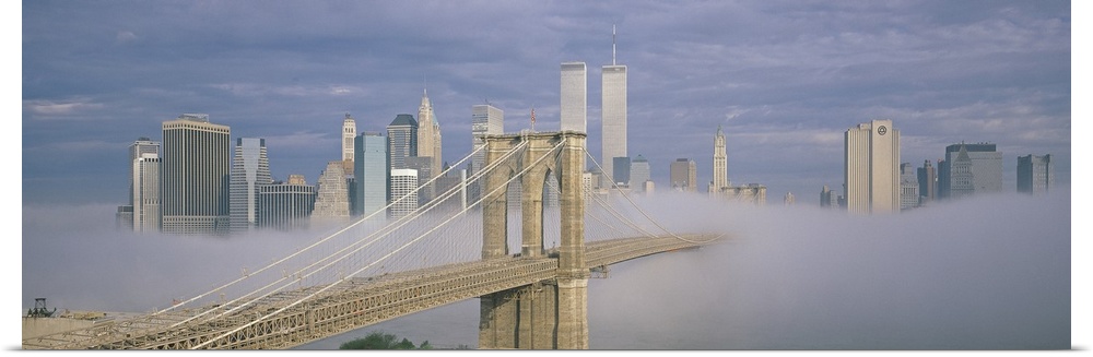 Panoramic photo on canvas of a bridge leading to the NYC skyline poking out of the fog.