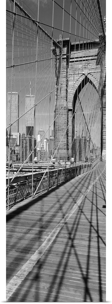 This vertical panoramic shaped photograph taken before 2001 shows one of the suspension towers of the bridge and the World...