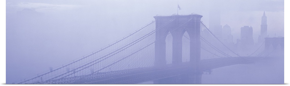 Panoramic photograph on a giant wall hanging of fog surrounding New York's famous Brooklyn Bridge.  Part of the New York C...