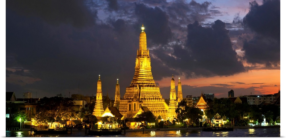 Buddhist temple lit up at dawn, Wat Arun, Chao Phraya River, Bangkok, Thailand