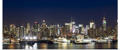 Buildings in a city lit up at dusk, Hudson River, Midtown Manhattan, Manhattan, New York City, New York State,