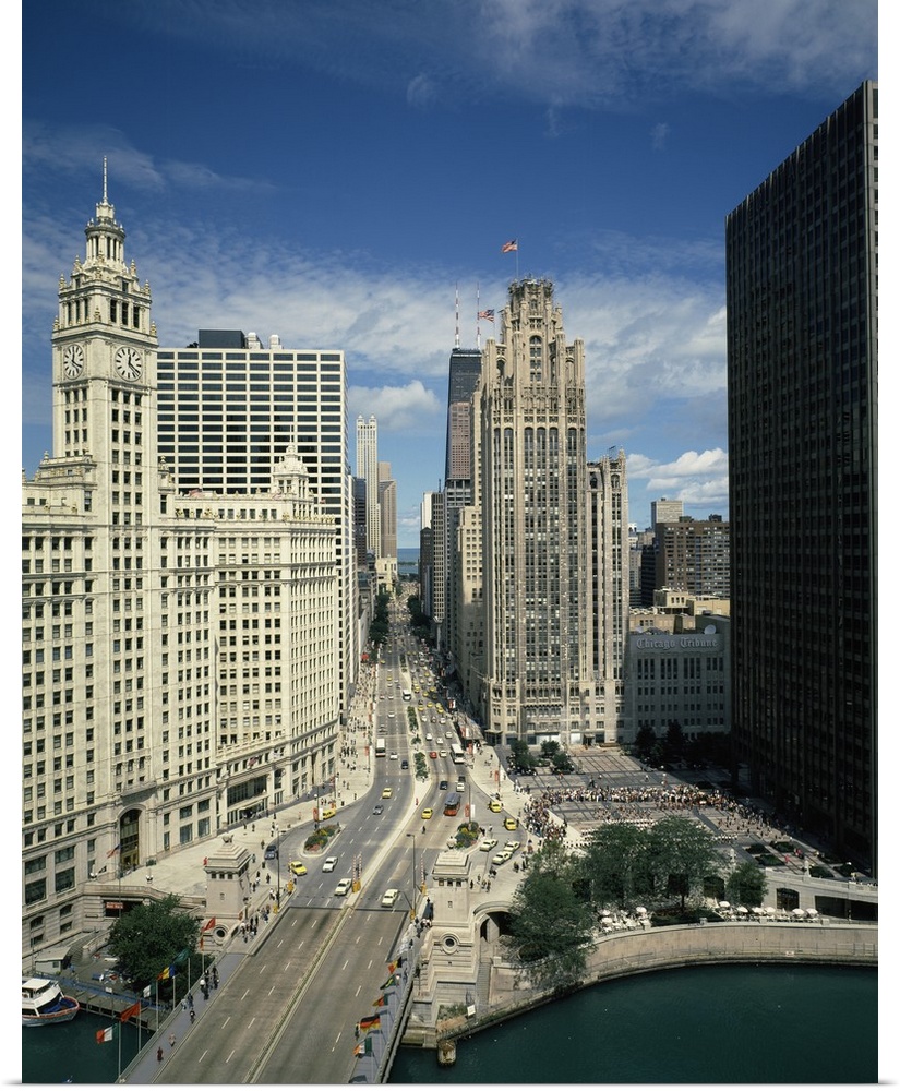 A large vertical piece of a bridge and street running through tall buildings in the city of Chicago.