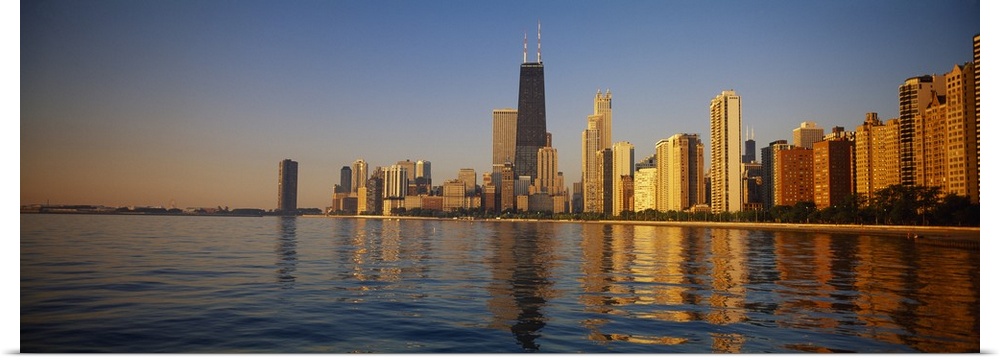Long horizontal photo of the skyline of Chicago meeting the water front at sunset printed onto canvas.