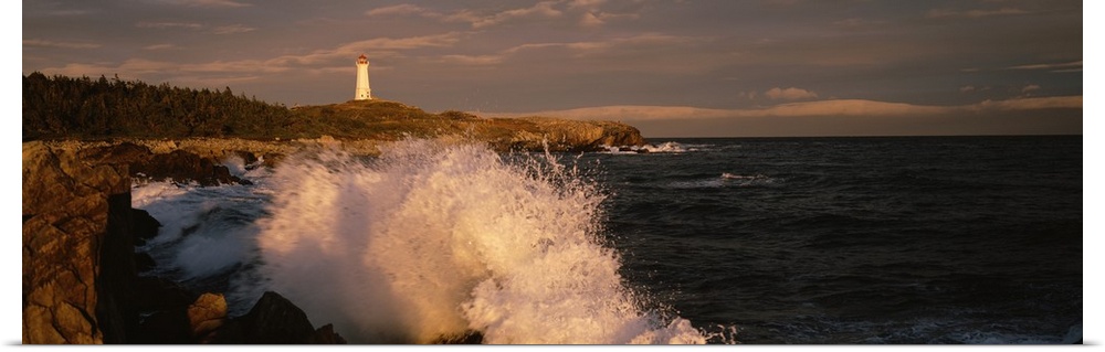 Canada, Nova Scotia, Cape Breton Island, Waves breaking on the rocks near Louisbourg lighthouse
