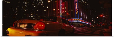 Car on a road, Radio City Music Hall, Rockefeller Center, Manhattan, New York City, New York State