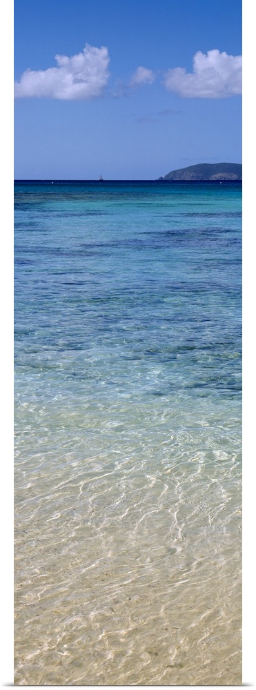 Tall and narrow canvas print of clear Caribbean ocean water with a mountain in the distance.