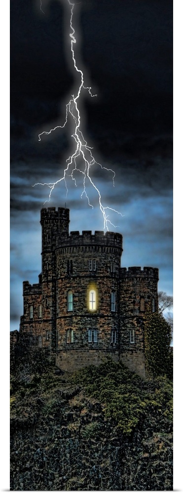 Giant, vertical photograph of lightening striking a castle on a hill, a single light can be seen through one window, on a ...