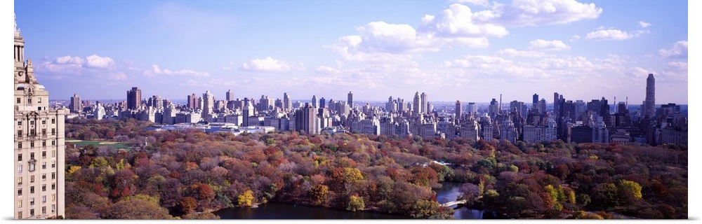 View from a skyscraper of the forests in Central Park in autumn, surrounded by the tall city buildings of New York.