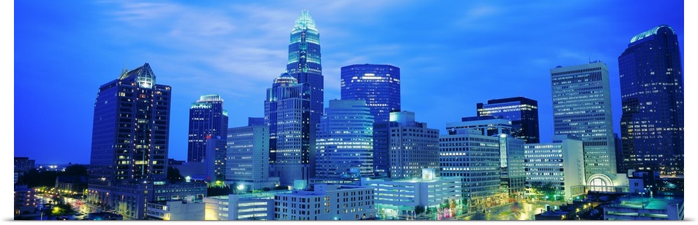 Giant, panoramic photograph of the Charlotte skyline at night.