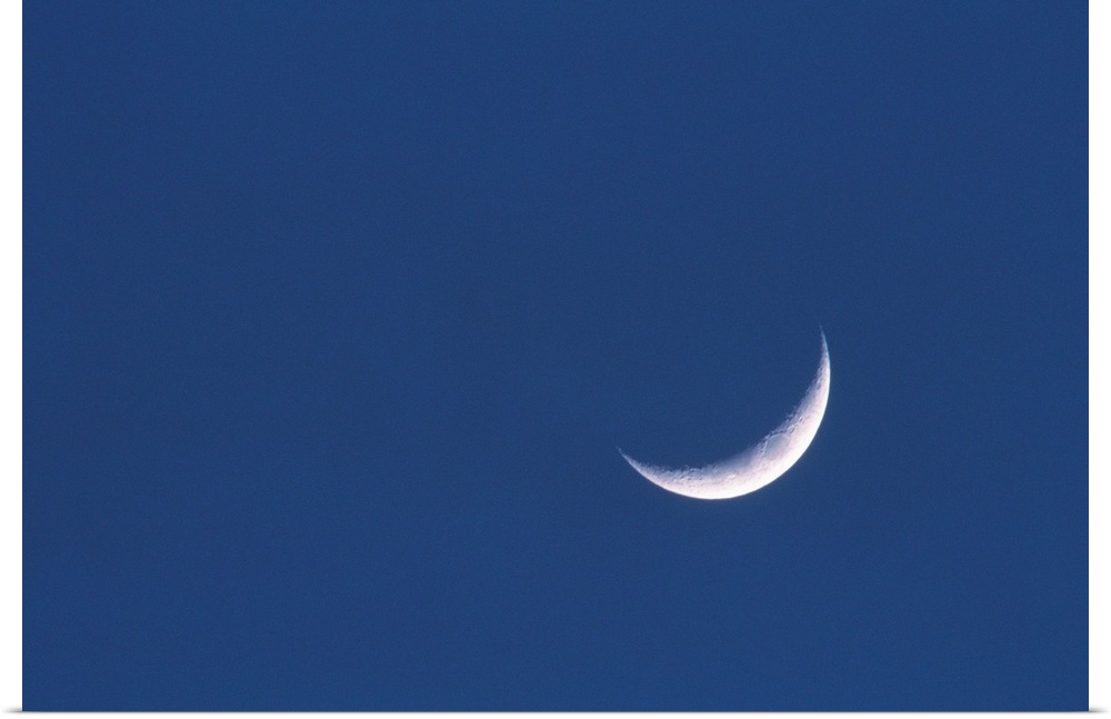 Crescent moon in deep blue sky