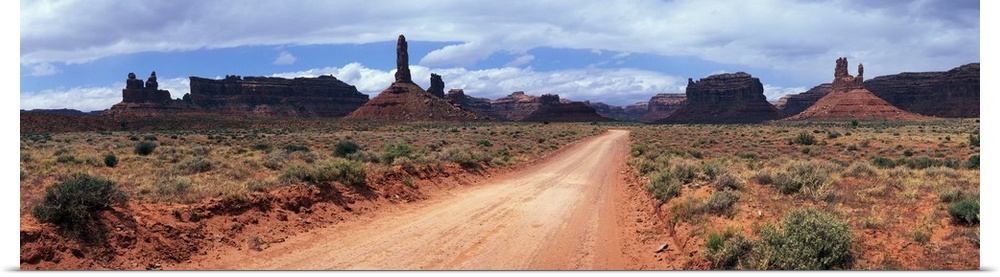 Dirt road through desert landscape with sandstone formations, Utah