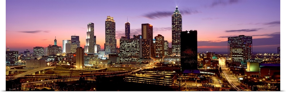 Panoramic photograph showcasing the busy city streets and large skyscrapers of Atlanta, Georgia taken at dusk.