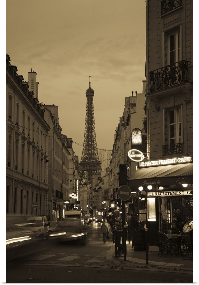 Vertical photo on canvas of a street with the Eiffel Tower in the background at dusk.