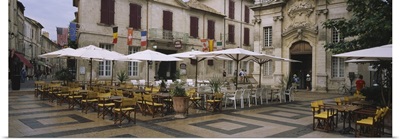 Empty chairs and tables at a sidewalk cafe, Avignon, Vaucluse, Provence-Alpes-Cote D'azur, France